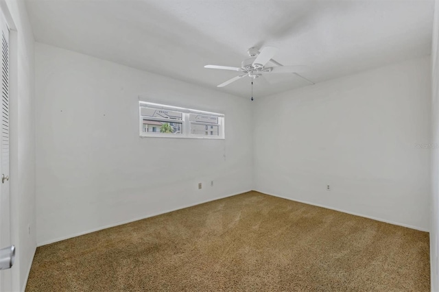 empty room featuring ceiling fan and carpet flooring