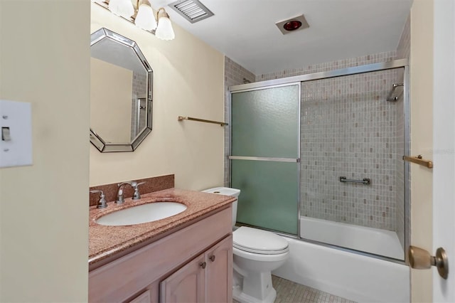 full bathroom with vanity, shower / bath combination with glass door, toilet, and tile patterned floors