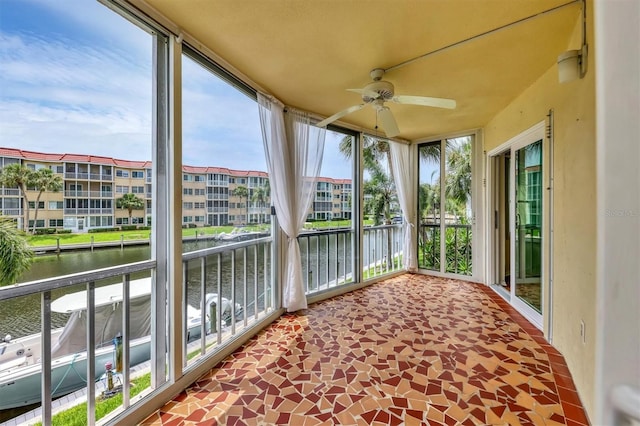 exterior space with a water view and ceiling fan