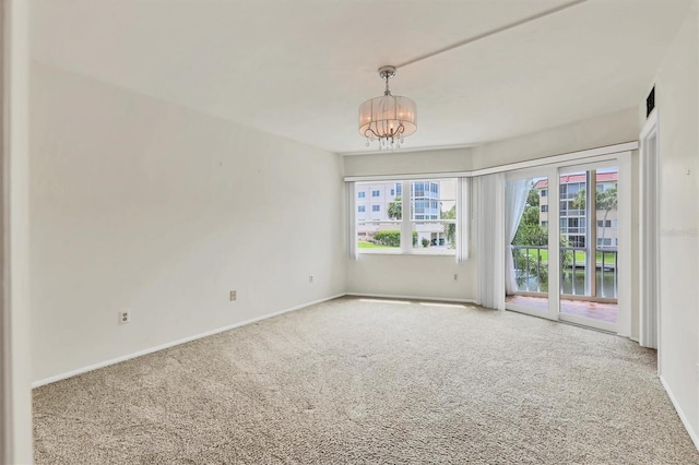 1300 N Portofino Dr Unit 208, Sarasota, FL 34242 - carpeted empty room with a chandelier and baseboards