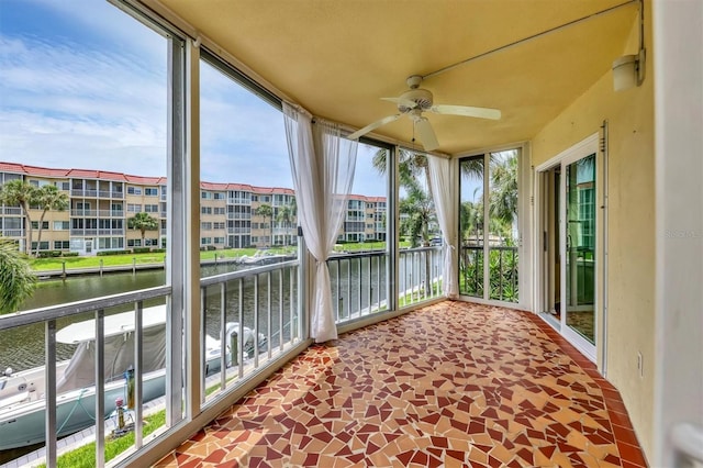 1300 N Portofino Dr Unit 208, Sarasota, FL 34242 - unfurnished sunroom featuring a water view and a wall of windows