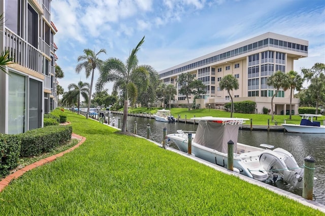 1300 N Portofino Dr Unit 208, Sarasota, FL 34242 - dock with a water view and a lawn