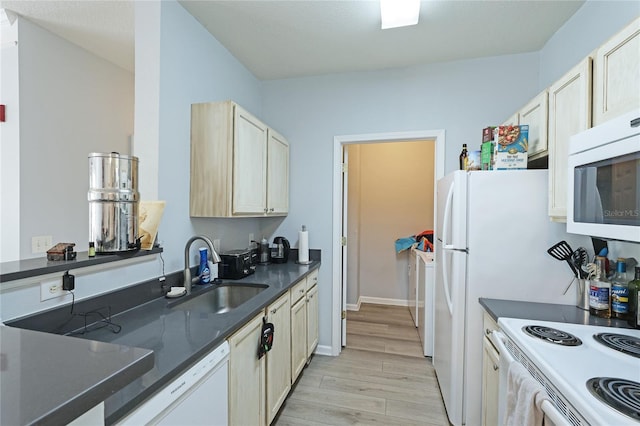 kitchen with light hardwood / wood-style floors, white appliances, and sink