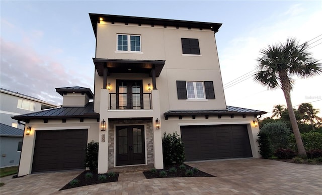 view of front facade with a balcony and a garage