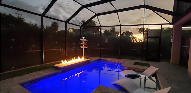 pool at dusk with a lanai