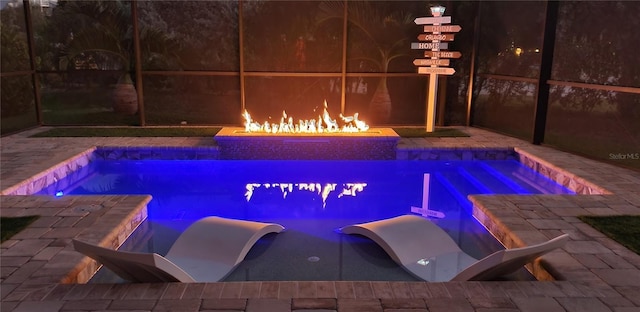 view of swimming pool featuring an outdoor fire pit