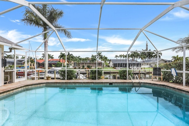 view of pool with a lanai and a water view