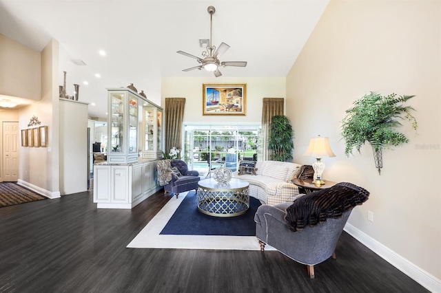 living room featuring dark wood-type flooring, high vaulted ceiling, and ceiling fan