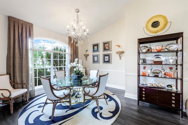 dining area with vaulted ceiling, dark hardwood / wood-style floors, and a chandelier