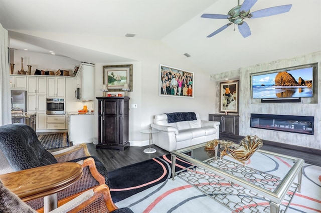 living room featuring ceiling fan, wood-type flooring, and vaulted ceiling