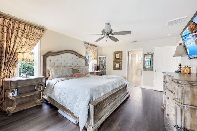 bedroom with ceiling fan, dark hardwood / wood-style flooring, and ensuite bath