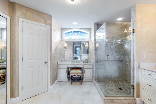 bathroom featuring vanity and a shower with shower door