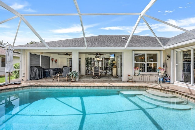 view of swimming pool featuring grilling area, a lanai, ceiling fan, and a patio area