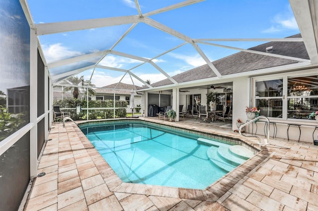 view of swimming pool with a patio and glass enclosure