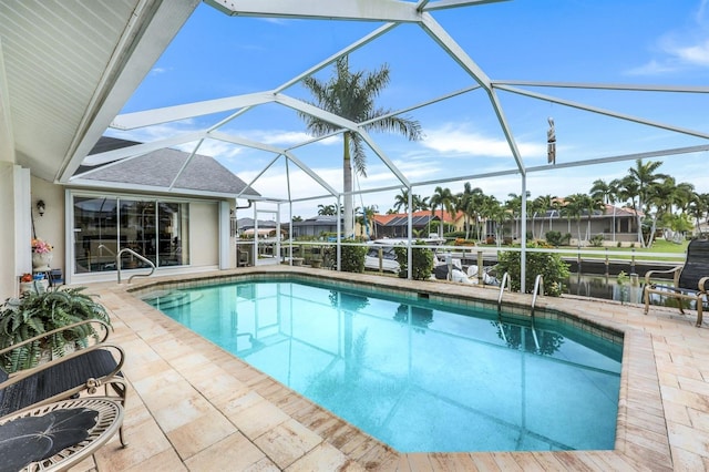 view of swimming pool featuring a lanai and a patio