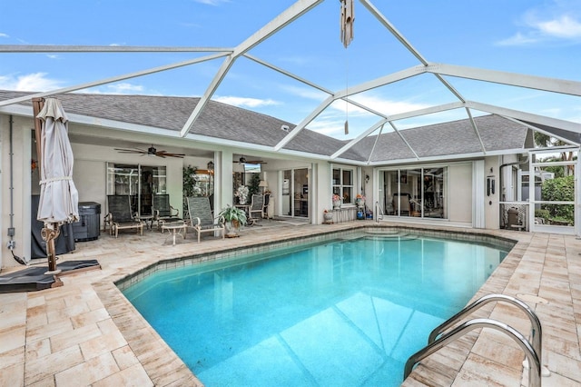 view of swimming pool featuring ceiling fan, central air condition unit, glass enclosure, and a patio