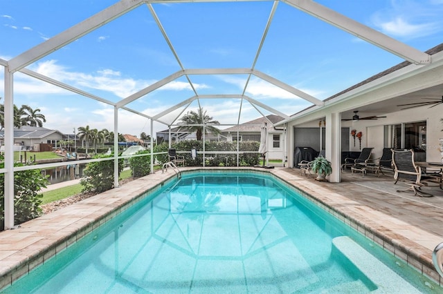 view of pool featuring ceiling fan, a lanai, and a patio