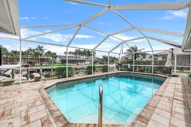 view of swimming pool featuring a lanai and a patio area