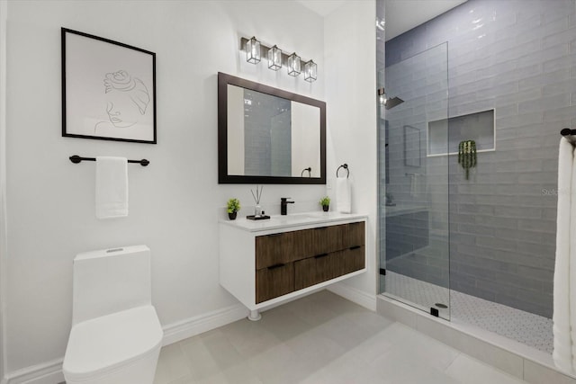 bathroom with tiled shower, tile patterned floors, vanity, and toilet