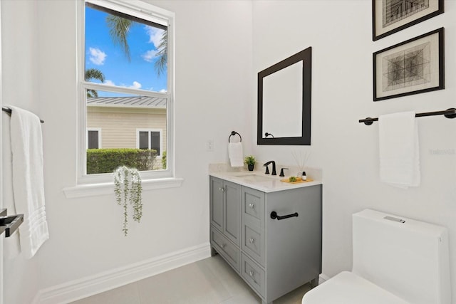 bathroom with tile patterned floors, vanity, and toilet