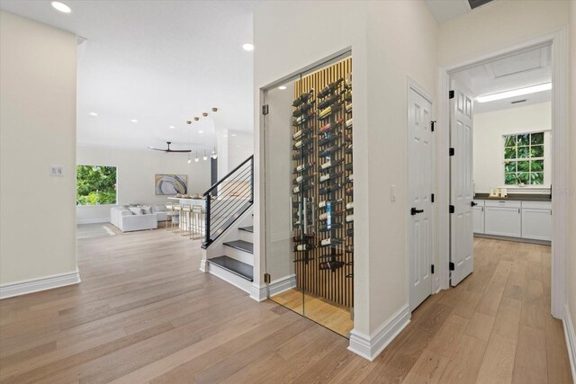 wine area with recessed lighting, baseboards, and light wood-style floors