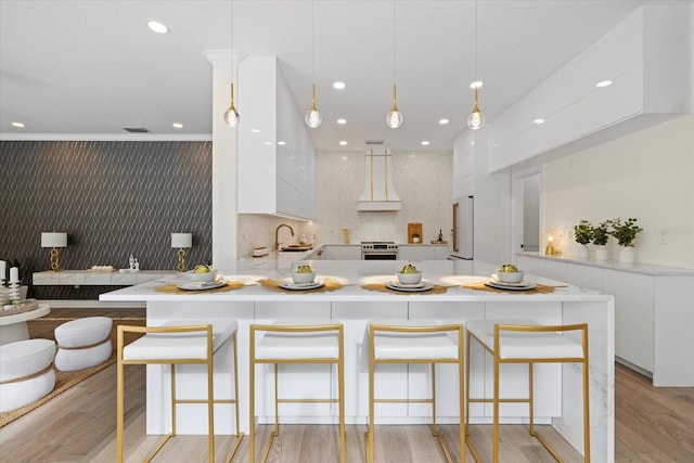 kitchen with stainless steel electric range oven, a peninsula, custom exhaust hood, white cabinets, and modern cabinets