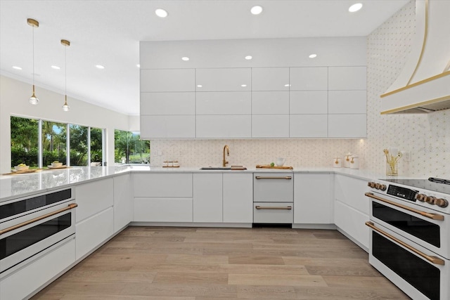 kitchen with white appliances, modern cabinets, white cabinets, and range hood