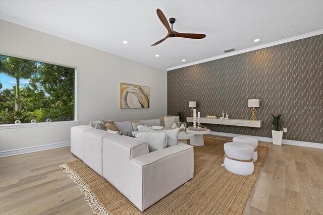 living room featuring wallpapered walls, crown molding, baseboards, recessed lighting, and wood finished floors