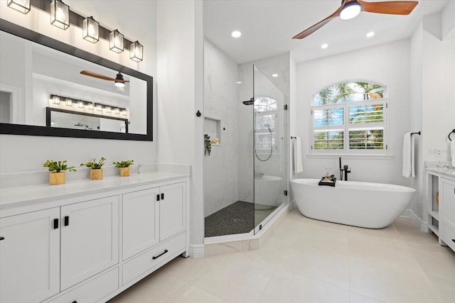 full bath featuring vanity, a ceiling fan, recessed lighting, a freestanding bath, and a shower stall