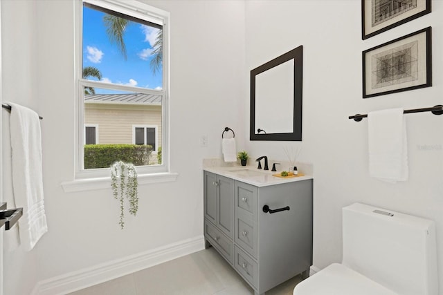 bathroom with vanity, tile patterned floors, toilet, and baseboards