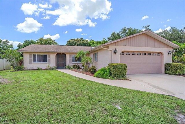 single story home with a front lawn and a garage