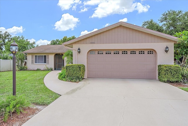 single story home featuring a garage and a front lawn