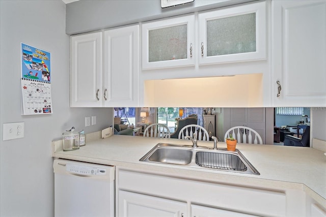 kitchen featuring white cabinetry, sink, and white dishwasher