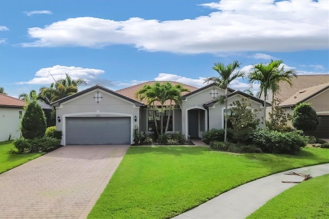 view of front of house with a front yard and a garage