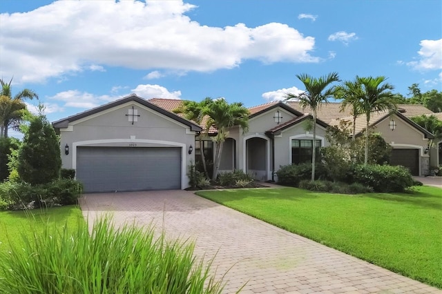 view of front of home featuring a front lawn and a garage