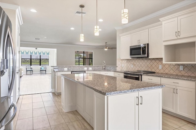 kitchen featuring white cabinetry, ceiling fan, hanging light fixtures, kitchen peninsula, and appliances with stainless steel finishes