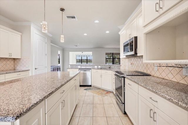 kitchen with stainless steel appliances, light tile patterned floors, tasteful backsplash, decorative light fixtures, and white cabinets