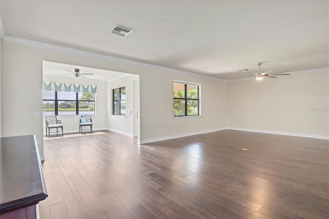 spare room featuring dark hardwood / wood-style flooring and ornamental molding