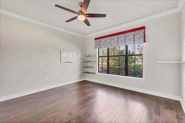 spare room featuring dark wood-type flooring, ceiling fan, and ornamental molding