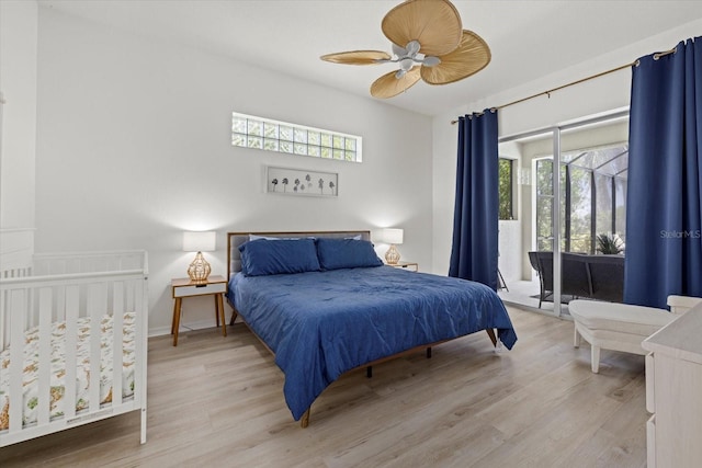 bedroom with access to exterior, ceiling fan, light hardwood / wood-style floors, and multiple windows