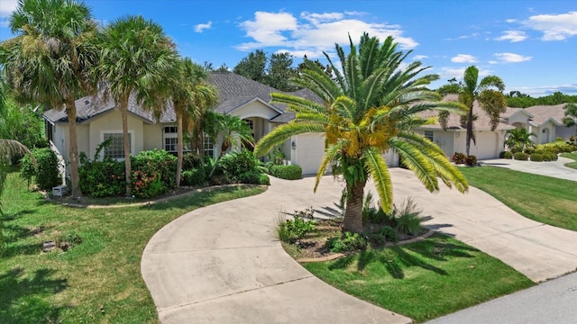 view of front of property featuring a garage and a front lawn