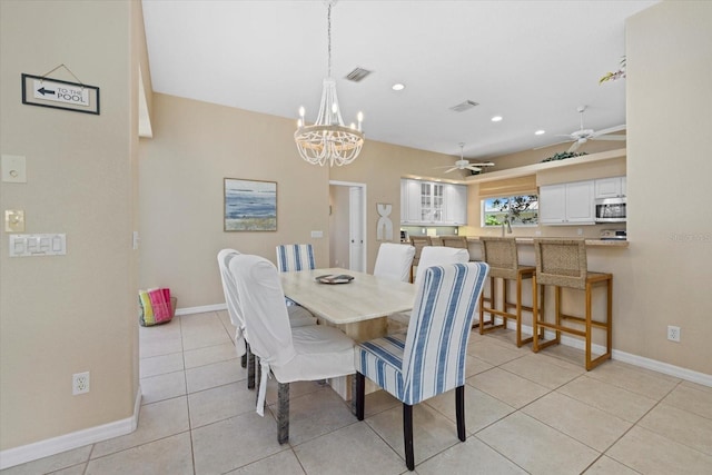 dining room featuring ceiling fan with notable chandelier and light tile patterned floors