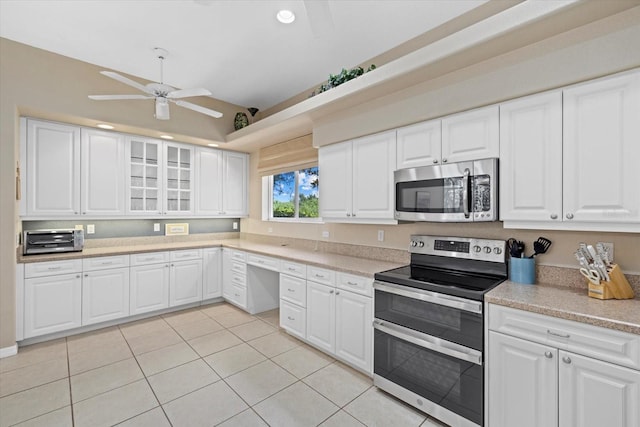 kitchen with white cabinets, stainless steel appliances, ceiling fan, and light tile patterned floors