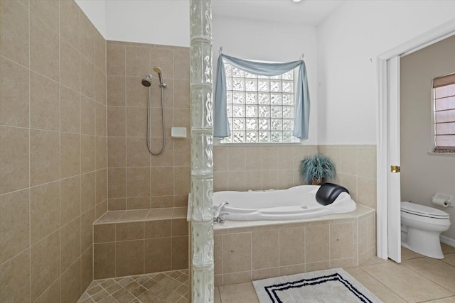 bathroom featuring toilet, separate shower and tub, and tile patterned flooring