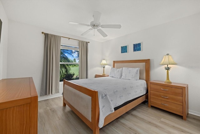 bedroom with ceiling fan and light hardwood / wood-style floors