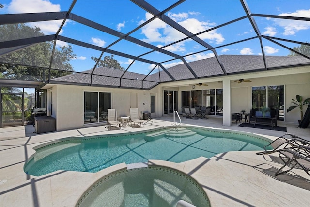 rear view of house with a patio, a pool with connected hot tub, stucco siding, and roof with shingles