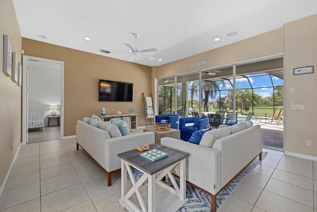 living room with light tile patterned floors, ceiling fan, a sunroom, and baseboards