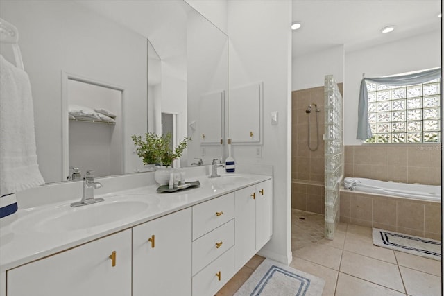 full bath with a walk in shower, double vanity, a sink, and tile patterned flooring
