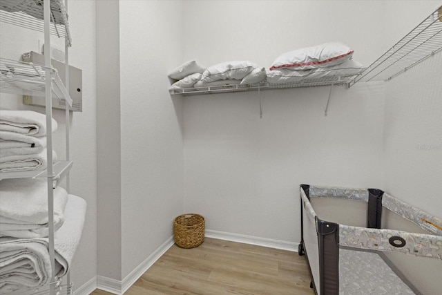 walk in closet with light wood-style flooring