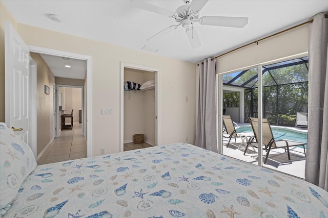 bedroom featuring access to outside, a spacious closet, tile patterned floors, a ceiling fan, and a sunroom